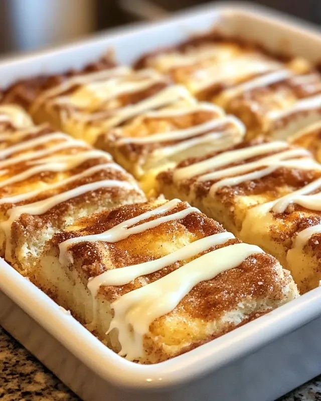 Cinnamon roll cheesecake bar on plate with fresh berries