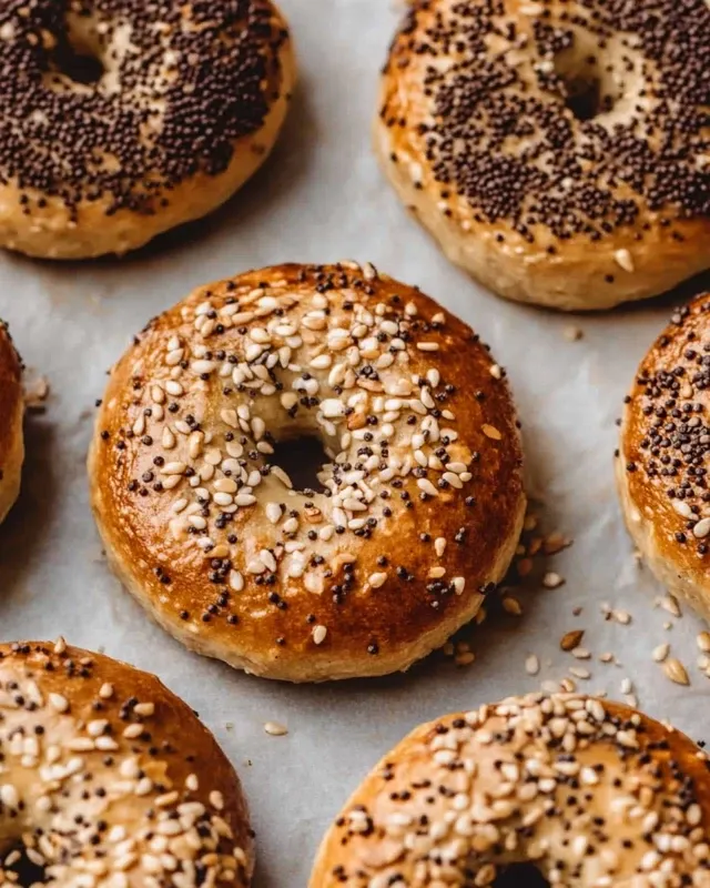 Freshly baked high protein bagels with everything seasoning on parchment paper