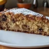 Banana pecan cake being served with vanilla ice cream