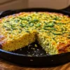 Jalapeño cornbread served with bowl of chili and honey butter