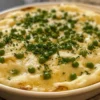 Served plate of creamed potatoes and peas alongside roasted chicken