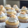 Adding whipped cream and pineapple topping to mini cheesecakes