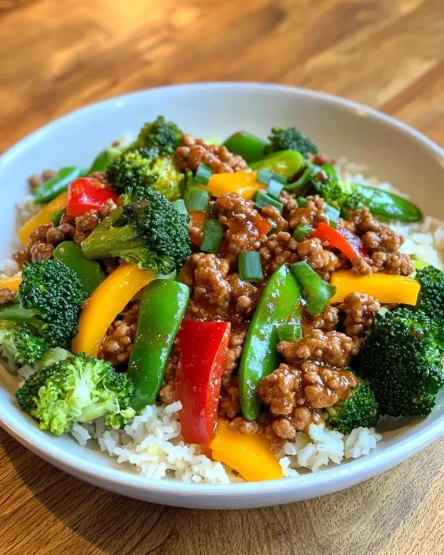 Completed high protein ground turkey stir-fry served over brown rice