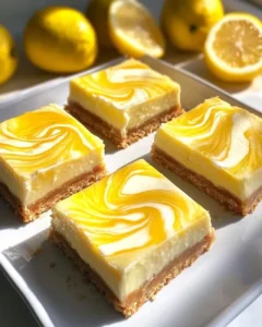 Finished lemon marbled cheesecake bars with fresh berries