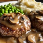 Simmering Salisbury steak in rich mushroom gravy in a skillet
