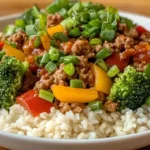 Completed high protein ground turkey stir-fry served over brown rice