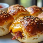 Bacon cheeseburger bombs on serving platter with dipping sauces