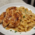 Complete meal of chicken with buttered noodles served with roasted vegetables