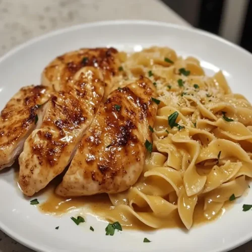 Complete meal of chicken with buttered noodles served with roasted vegetables