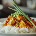 Finished plate of orange chicken with rice and vegetables