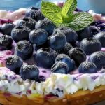 Golden blueberry cottage cheese breakfast bake in 8x8 baking dish fresh from oven