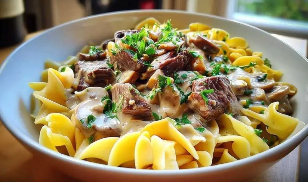 Classic family-style beef stroganoff served over egg noodles with fresh parsley garnish
