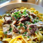 Beef strips browning in skillet for classic family-style beef stroganoff recipe