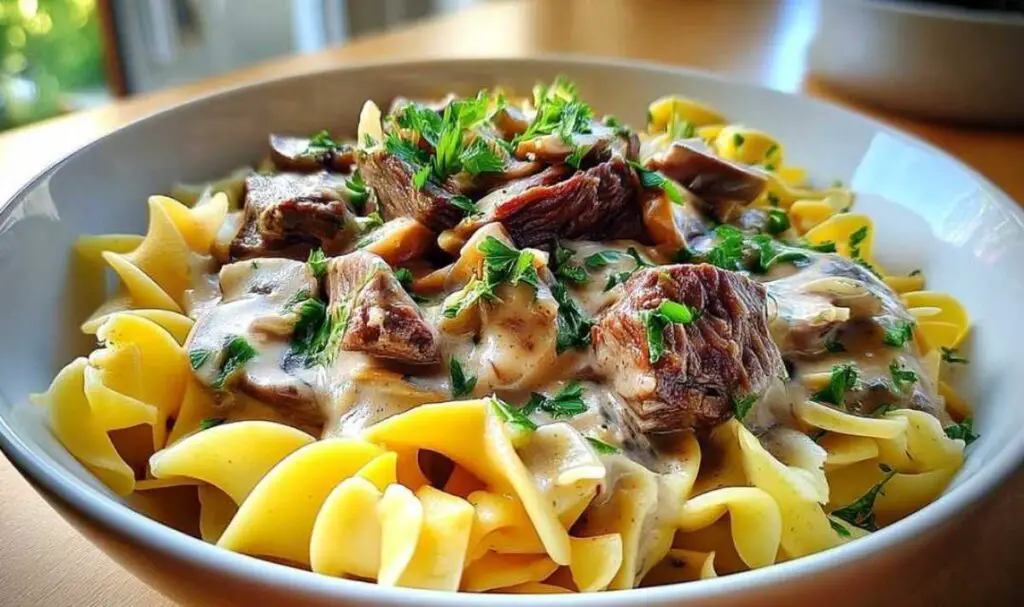 Fresh ingredients for classic family-style beef stroganoff including beef, mushrooms, and sour cream