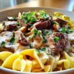 Fresh ingredients for classic family-style beef stroganoff including beef, mushrooms, and sour cream