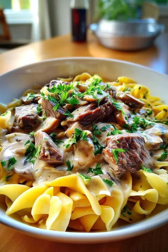 Fresh ingredients for classic family-style beef stroganoff including beef, mushrooms, and sour cream