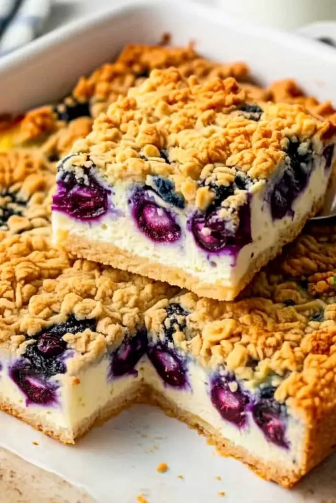 Slice of Cottage Cheese Breakfast Bake on white plate showing creamy interior with blueberries and crumble topping