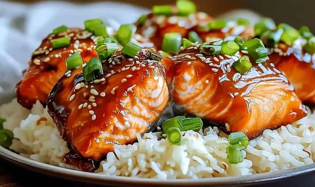 Baked ginger soy glazed salmon garnished with green onions and sesame seeds
