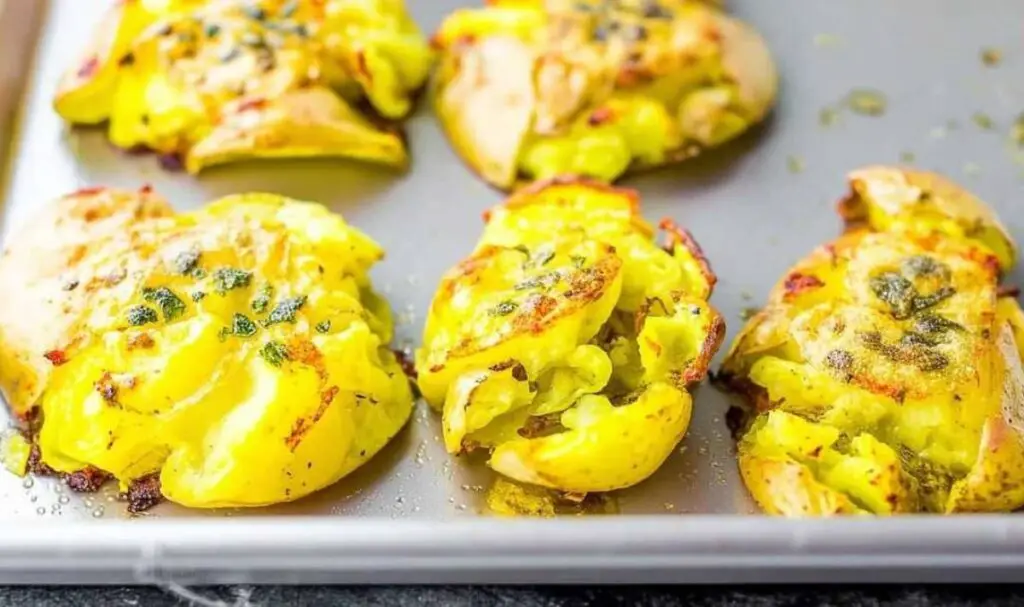 Smashing boiled potatoes with masher for smashed potatoes recipe