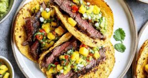 Fresh avocado salsa with diced tomatoes cilantro and lime juice in bowl