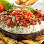 Mixing creamy BLT dip base with electric mixer in glass bowl showing smooth texture