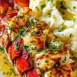 Elegant plated baked lobster tails with garlic herb butter and mashed potatoes ready to serve