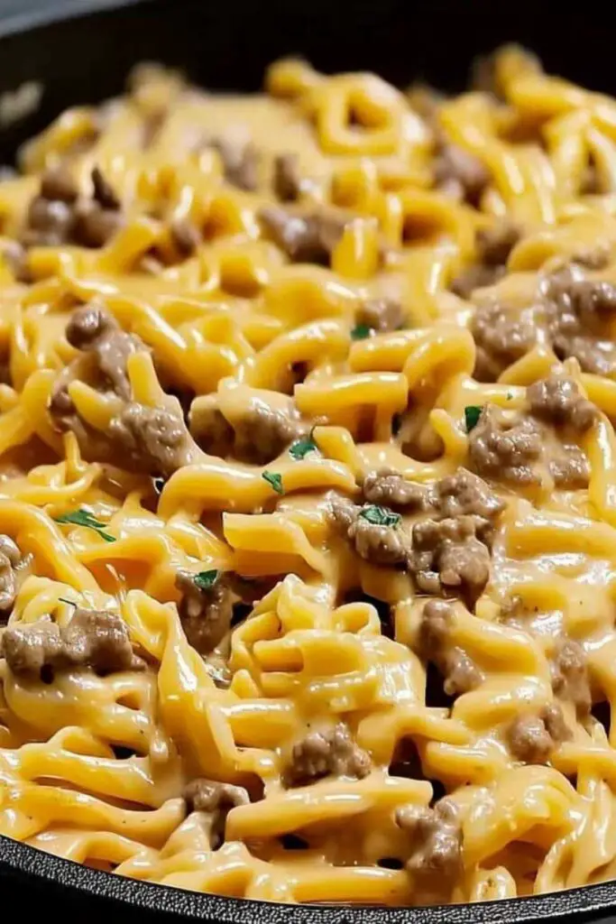 Beef and garlic butter pasta served in white bowl with fresh parsley garnish