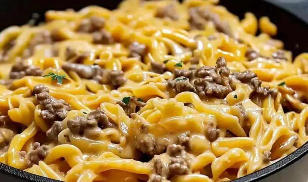 Ground beef cooking with garlic and butter in large pot for pasta recipe