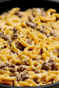 Beef and garlic butter pasta ingredients laid out including ground beef pasta garlic butter