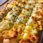 Cheesy garlic breadsticks ingredients including pizza dough, butter, garlic, and mozzarella cheese