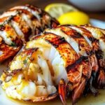 Finished creamy garlic butter lobster tails with cream sauce and parsley garnish