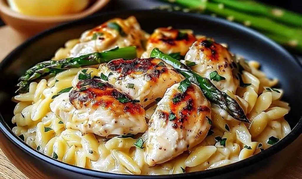 Creamy Parmesan orzo chicken served in white bowl garnished with fresh parsley
