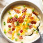 Baked potato soup ingredients including russet potatoes bacon cheese and milk