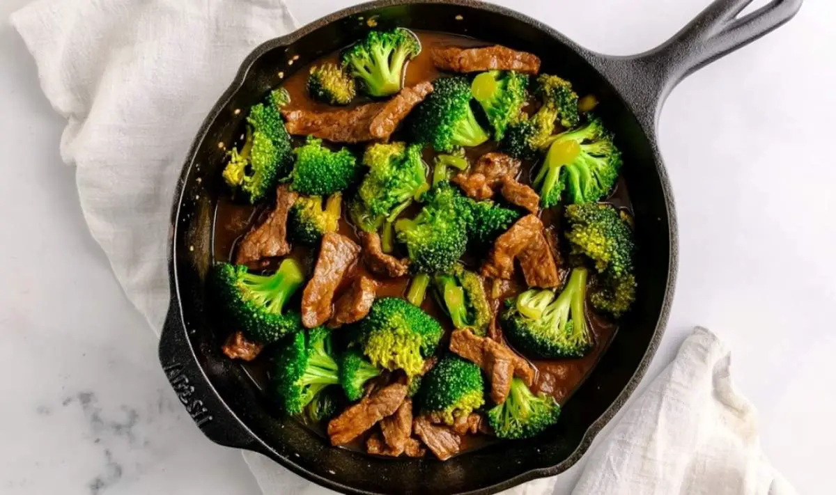 Beef strips cooking in hot skillet for beef and broccoli stir fry