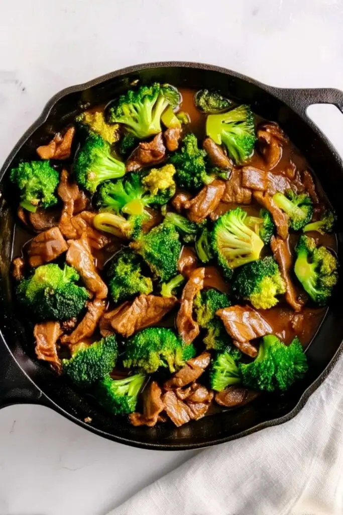 Beef strips cooking in hot skillet for beef and broccoli stir fry