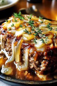 Sliced French onion meatloaf showing tender interior with melted cheese and caramelized onions