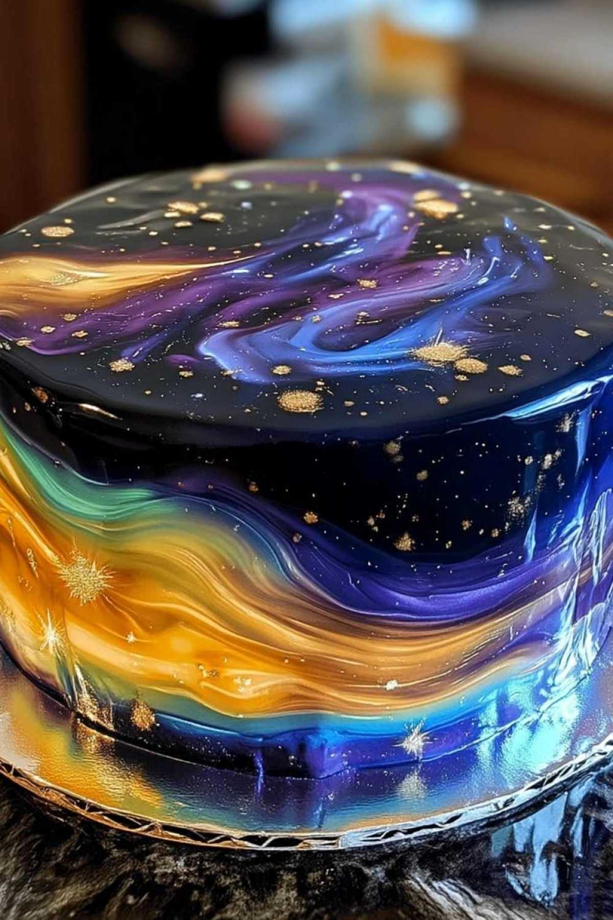 Pouring colorful mirror glaze over chilled cake layers for Galaxy Mirror Cake recipe
