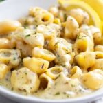 Garlic butter pasta ingredients including fresh garlic, Parmesan cheese, pasta, and herbs
