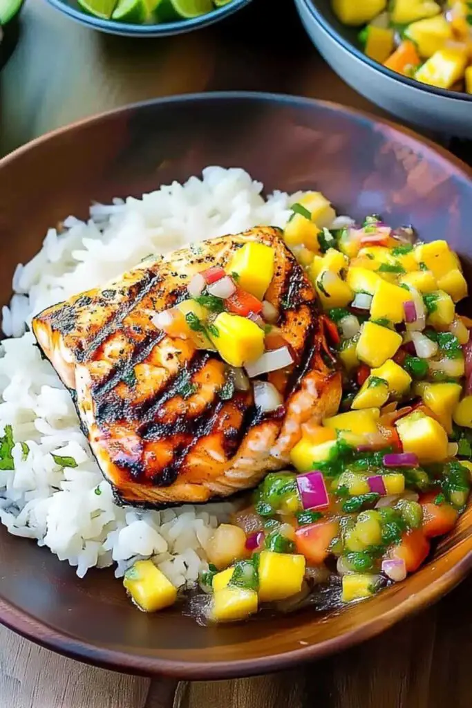 Grilled salmon with mango salsa and coconut rice served on white plate