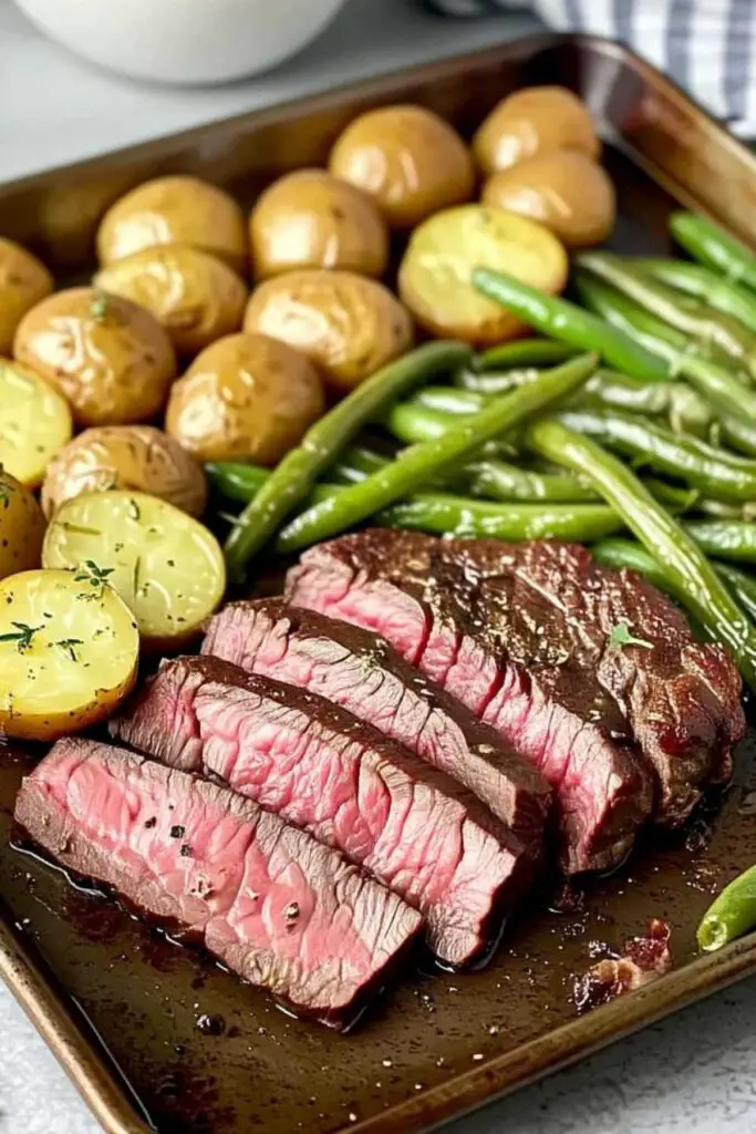 Sliced herbed steak with roasted vegetables plated for serving
