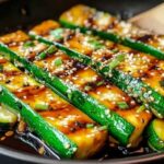 Fresh zucchini slices with soy sauce sesame oil and seasonings for hibachi recipe