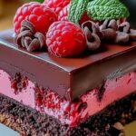 Chocolate ganache being poured over raspberry chocolate mousse cake creating glossy finish