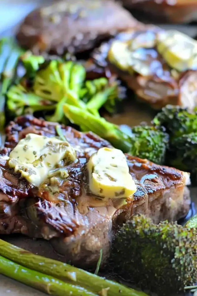 Keto steak and veggies sheet pan with sirloin, broccoli, and asparagus topped with rosemary caper butter