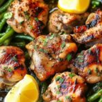 Chicken thighs searing in cast iron skillet for lemon garlic butter recipe