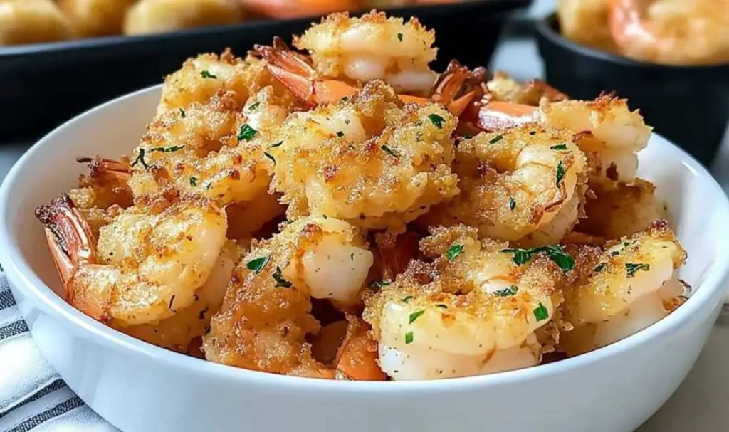 Golden brown magic crispy baked shrimp with fresh parsley garnish served on white plate