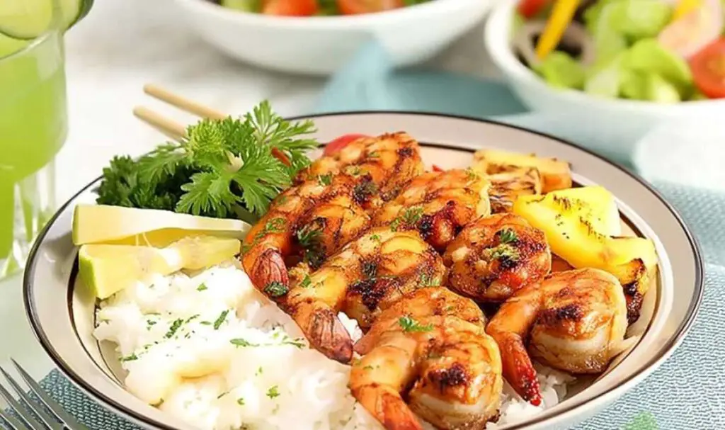 Marinated grilled shrimp served over rice with grilled pineapple and bell peppers