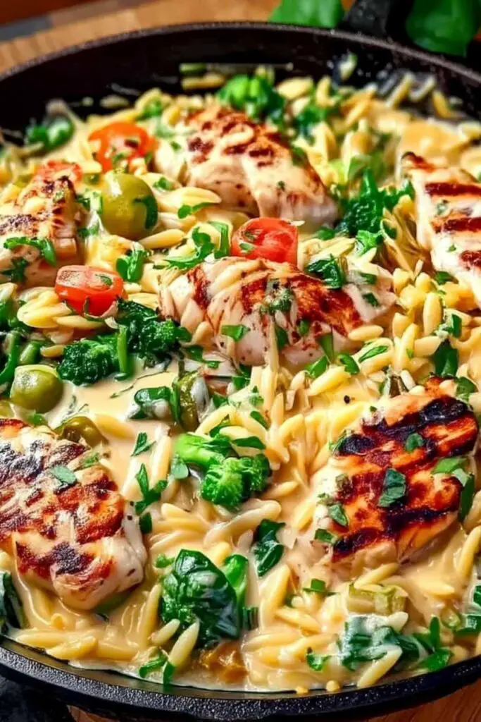Searing chicken breasts for Mediterranean creamy chicken orzo in large skillet
