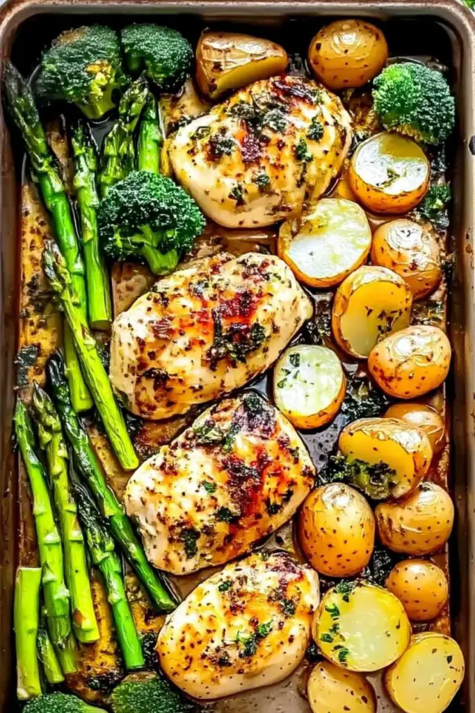 Sheet pan garlic butter chicken and veggies with golden potatoes and crisp asparagus