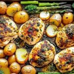 Close up of sliced garlic butter chicken with roasted vegetables on dinner plate