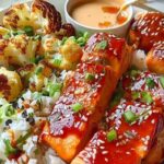Glazed salmon cooking in skillet with sriracha honey sauce bubbling